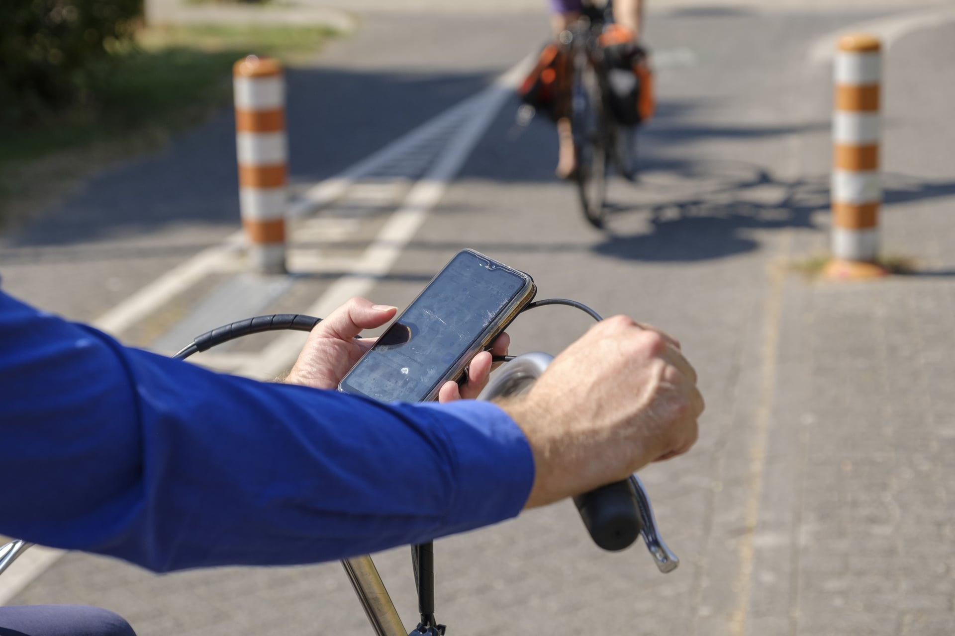 Een man staat stil en zit op zijn telefoon